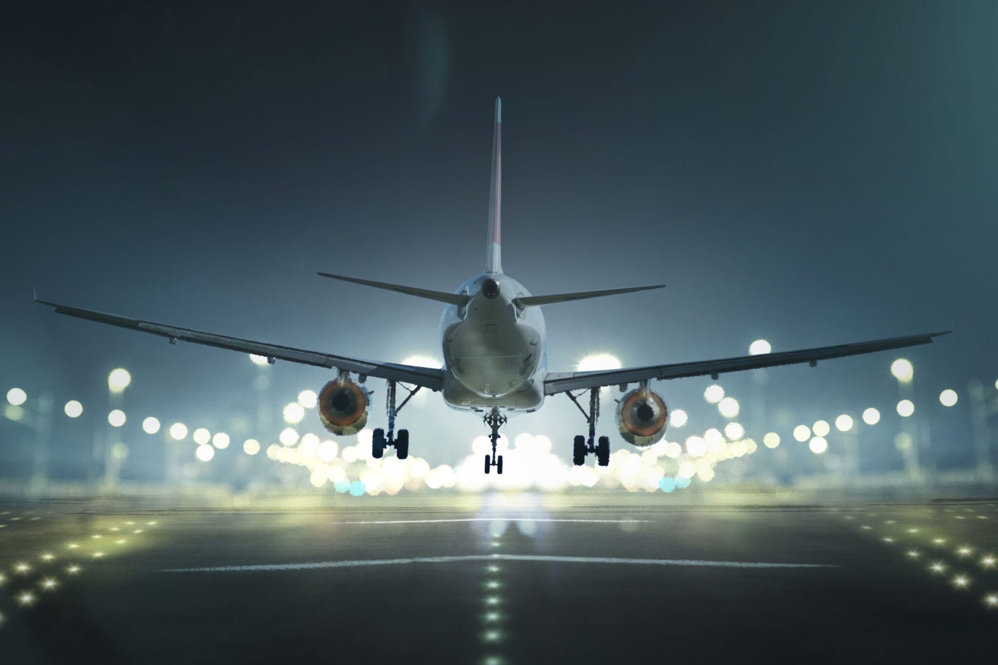 The cover of the ACI Annual Report 2022 features a commercial airplane from behind, illuminated by bright lights as it takes off or lands at night, with blurred runway lights in the background.